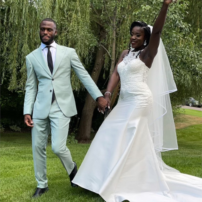 Wedding couple holding hands and walking outdoors